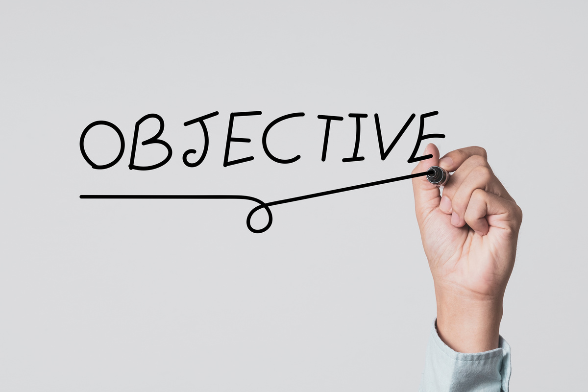 Concentrate setup objectives target and business goal ,Hand writing objective wording on board.